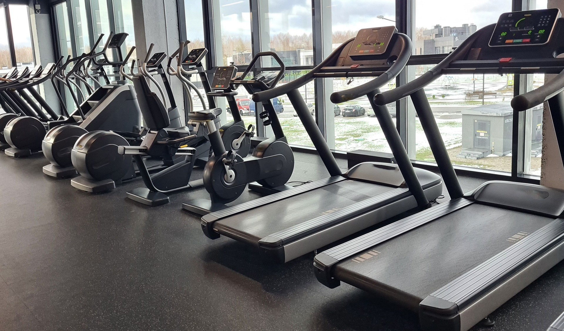 Modern Fitness Center With Treadmills And Stationary Bikes
